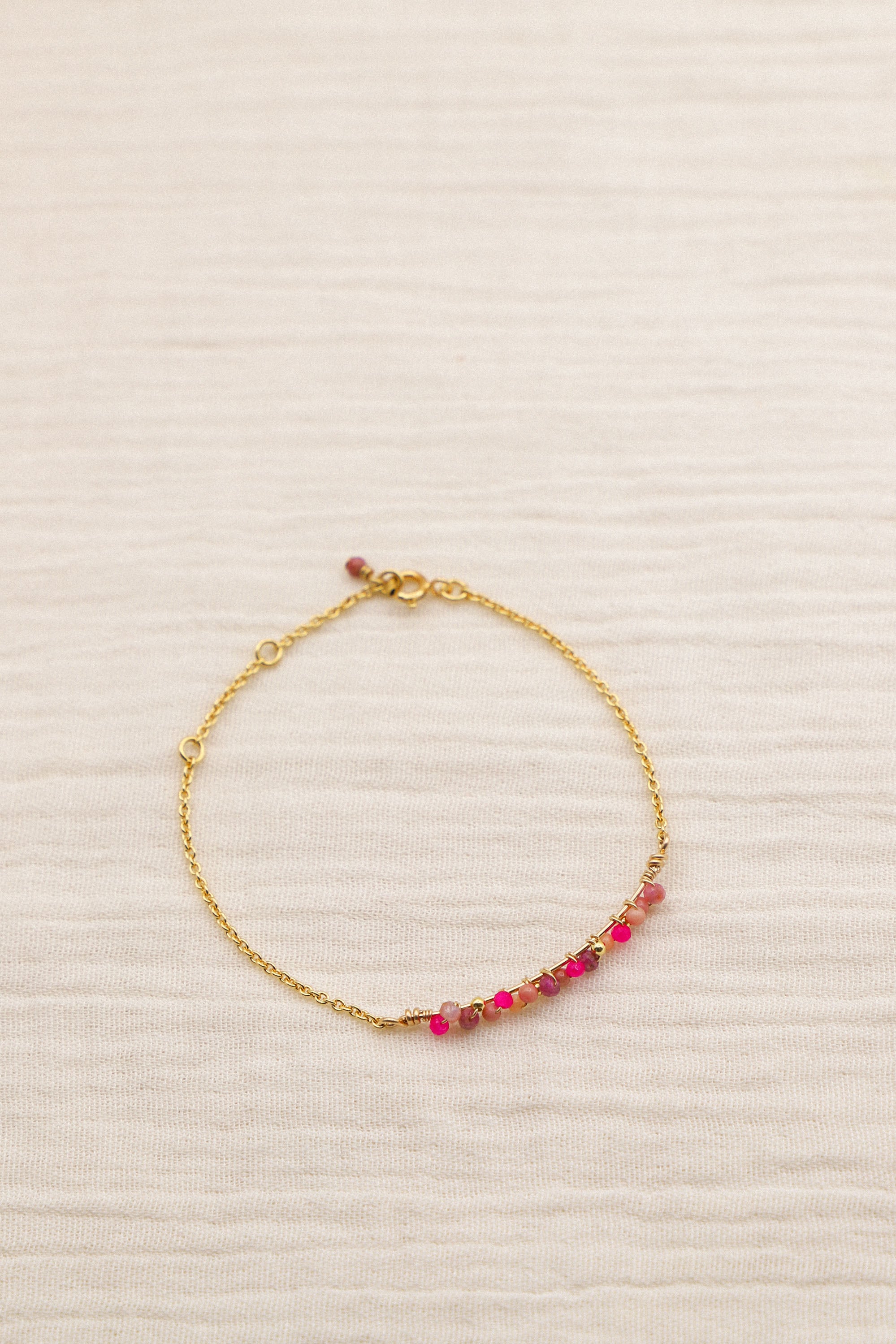 Bracelet Amy composé de perles roses tissées. Le tout, plaqué or 24 carats.